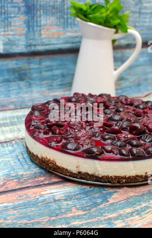 Cold cheesecake with cherry jelly on table Stock Photo