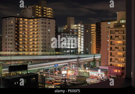 Esaka, Japan - November 22, 2015: Tall apartment buildings in commuter neighborhood of Osaka at night Stock Photo