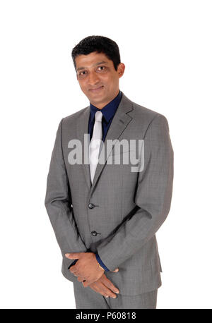 A waist up image of a handsome business man in a gray suit and blue shirt standing isolated for white background Stock Photo