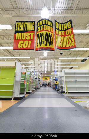 'Going out of business' signs hang inside a nearly empty Toys R Us store in Manchester, N.H., USA., on June 25, 2018. Stock Photo