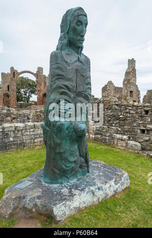 Bronze statue of Cuthbert of Farne by Fenwick Lawson ARCA 20 March 2001 in the ruins of Lindisfarne Priory Holy Island Northumbria Stock Photo