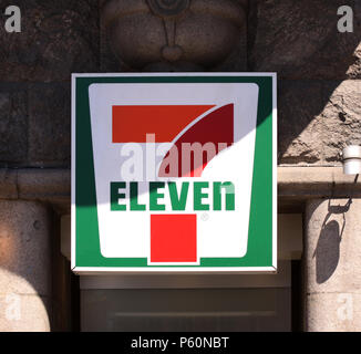 Copenhagen, Denmark - June 26, 2018: 7 eleven logo sign on a wall. 7-Eleven is an international chain of convenience stores that operates primarily as Stock Photo