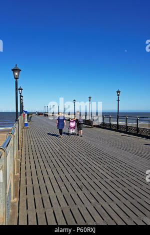 Skegness, Lincolnshire,UK,  pier with a wind farm on the horizon Stock Photo