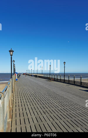 Skegness, Lincolnshire,UK,  pier with a wind farm on the horizon Stock Photo