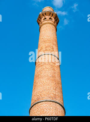 Tall round red brick Victorian industrial tower against blue sky, Canning graving dock and Albert Dock, Liverpool, England, UK Stock Photo