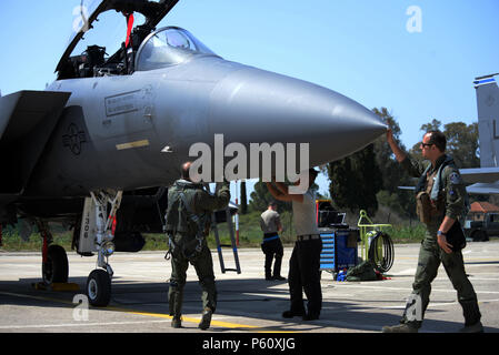 A pilot, weapon systems officer, and maintenance Airmen from the 48th Fighter Wing, Royal Air Force Lakenheath, England, inspect an F-15E Strike Eagle aircraft prior to a mission, April 4, 2016, during exercise INIOHOS 16 at Andravida Air Base, Greece. Twelve F-15E Strike Eagles from the 492nd Fighter Squadron and approximately 260 U.S. Air Force Airmen are participating in the training event through April 15, 2016. (U.S. Air Force photo by Tech. Sgt. Eric Burks/Released) Stock Photo