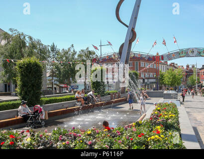 Lisburn, County Antrim, Northern Ireland. 27 June 2018. UK weather - a scorching hot day in the city of Lisburn with temperatures hitting 27C. Children play and cool off in the water jets in the town square. Credit: David Hunter/Alamy Live News. Stock Photo