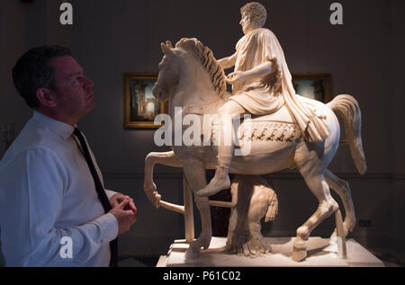 London Art Week, St James’s, London, UK. 28 June, 2018. A preview of galleries participating in London Art Week before official launch at 3.00pm on 28 June. Photo: Raffaello Tomasso with equestrian Statue of Emperor Marcus Aurelius. Tomasso Brothers Fine Art gallery. Credit: Malcolm Park/Alamy Live News. Stock Photo