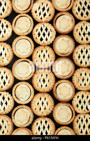 Home made Christmas mince pies forming and abstract background. Flat lay. Stock Photo