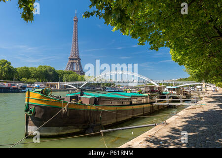 Paris, France - 23 June 2018: Residential barge on the Seine River with Eiffel Tower in background Stock Photo