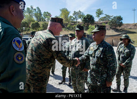 Lt. Gen. Lawrence Nicholson, commanding general of III Marine Expeditionary Force and Joint Task Force commander for Balikatan 16, shakes hands with Lt. Col. Japzon of 2nd Marine Battalion, Philippine Marine Corps during a joint visit from both the Philippine and U.S. leadership to the training grounds of BK16 in Crow Valley, Philippines, April 7, 2016. In its 32nd iteration, Balikatan provides the opportunity for U.S. and Philippine forces to work “shoulder to shoulder” and hone their combined readiness in response to crises and conflict throughout the Indo-Asia-Pacific region. (U.S. Air Forc Stock Photo