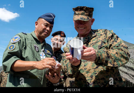 Brig. Gen. Laurcris Tumanda, 710th Special Operations Wing Commander, Armed Forces of the Philippines presents a gift  to Lt. Gen. Lawrence Nicholson, commanding general III Marine Expeditionary Force and the Joint Task Force  commander for Balikatan 16, during a joint visit from both the Philippine and U.S. leadership to the training grounds of  BK16 in Crow Valley, Philippines, April 7, 2016. In its 32nd iteration, Balikatan provides the opportunity for U.S. and  Philippine forces to work “shoulder to shoulder” and hone their combined readiness in response to crises and conflict throughout t Stock Photo