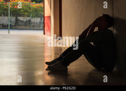 Emotional moment: man sitting holding face in hands, stressed sad young male having mental problems, feeling bad, depressed, disappointed, hopeless. D Stock Photo