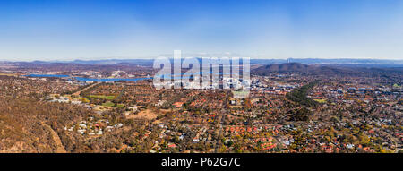 Wide elevated aerial panorama of Canberra city CBD suburb and Capitol hill federal district around lake Burley Griffin. Stock Photo