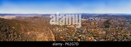 From airport field through Lake Burley Griffin and surrounding suburbs to TV tower and city CBD of Canberra in Australian capital territory Stock Photo