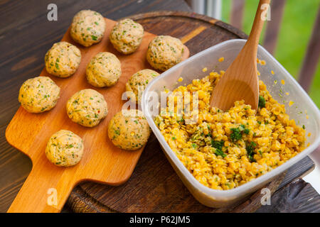 fish cakes and lentils on a wooden table Stock Photo