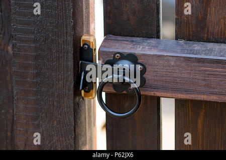 Metal rusty round handle on wooden door. Stock Photo