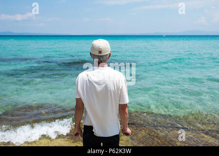 Senior man enjoying seaside view on the summer vacation Stock Photo