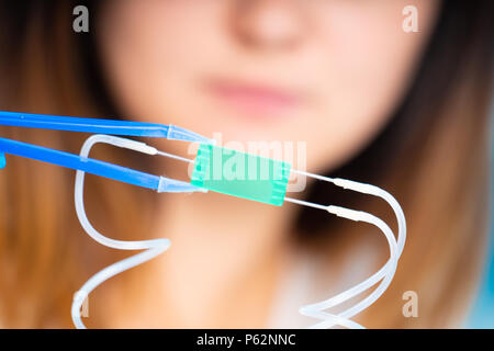 technician girl with microfluidic device LOC in microbiological lab Stock Photo