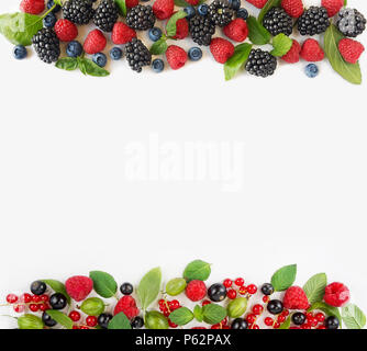 Various fresh summer berries isolated on white background. Ripe blueberry, raspberry, currant and blackberry with basil leaves. Berries at border of i Stock Photo