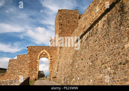 Gate to the town and Montalcino Fortress wall in Val d'Orcia, Tuscany, Italy. The fortress was built in 1361 atop the highest point of the town. Stock Photo