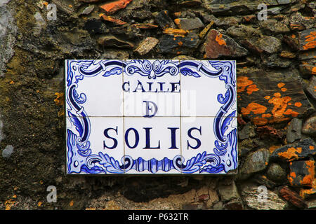 Street sign on a stone wall in Colonia del Sacramento, Uruguay. It is one of the oldest towns in Uruguay Stock Photo