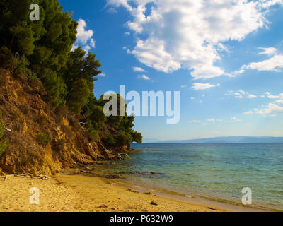 Beautiful seascape with rocky coastline and pine trees at the Aegean Sea near Koukounaries Beach in Skiathos, Greece Stock Photo