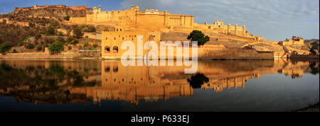 Panorama of Amber Fort reflected in Maota Lake near Jaipur, Rajasthan, India. Amber Fort is the main tourist attraction in the Jaipur area. Stock Photo