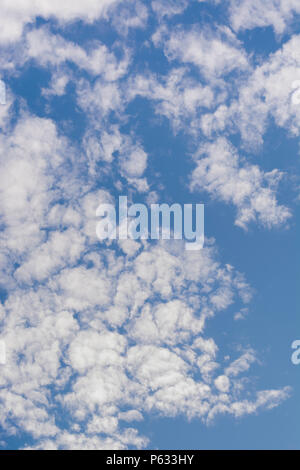 Blue summer sky with fluffy white clouds. Blue sky thinking. Stock Photo