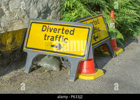 Yellow 'Diverted Traffic' sign. Temporary road closure concept, and traffic management. Stock Photo