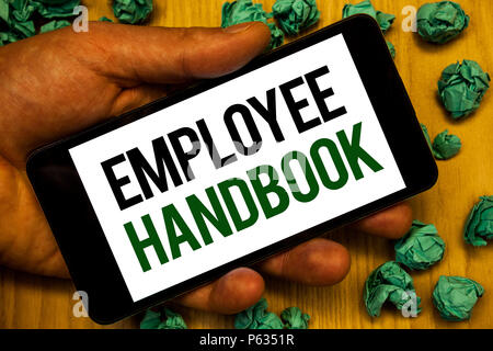 Handwriting text Employee Handbook. Concept meaning Document Manual Regulations Rules Guidebook Policy Code Hand holding phone white screen written wo Stock Photo