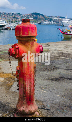 Ancient fire pump of water in the port of Sanremo. Useful to indicate security in marine ports Stock Photo