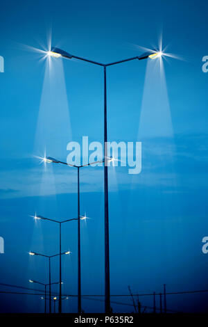 street lights at night over blue sky. Stock Photo