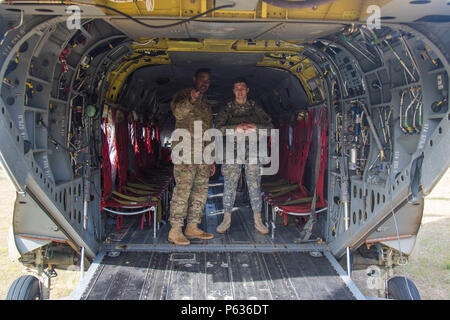 Sgt. 1st Class Marcus Gatt, a jumpmaster with 2nd Battalion, 505th Parachute Infantry Regiment, 3rd Brigade Combat Team, 82nd Airborne Division, speaks with a young paratrooper about jumping out of a CH-47 Chinook during the Saturday Proficiency Jump Program, Fort Bragg, N.C. April 16. As a jumpmaster, Gatt is responsible for the safety of the paratroopers in his chalk. (Army photo bby Staff Sgt. Christopher Freeman) Stock Photo