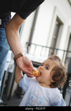 kid eating omelette with her hands Stock Photo