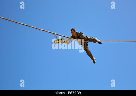 U.S. Army Ranger moves across a rope to touch the U.S. Army Ranger tab ...