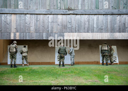 U.S. Soldiers with Alpha Company, Allied Forces North Battalion, U.S. Army NATO Brigade, comment the zeroing performed by German Soldiers assigned to Joint Forces Command Brunssum, who qualify with an M4 carbine in the Dutch Army outdoor firing range in Budel, the Netherlands, April 13, 2016.This qualification session led by Alpha Company was the first with participation of Allied forces assigned to JFC Brunssum. (U.S. Army photo by Visual Information Specialist Pierre-Etienne Courtejoie/Released) Stock Photo