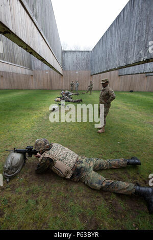 U.S. Soldiers with Alpha Company, Allied Forces North Battalion, U.S. Army NATO Brigade, advise German, French and Italian Soldiers assigned to Joint Forces Command Brunssum who perform M4 carbine qualification in the Dutch Army outdoor firing range in Budel, the Netherlands, April 13, 2016. This qualification session led by Alpha Company was the first with participation of Allied forces assigned to JFC Brunssum. (U.S. Army photo by Visual Information Specialist Pierre-Etienne Courtejoie/Released) Stock Photo