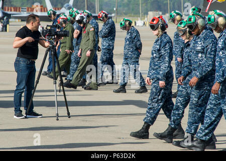 160419-N-YR571-076 VIRGINIA BEACH, Va. (April 19, 2016) Tim Hardiman, producer and cameraman for the Country Music Television show “Southbound,” films a foreign object damage walk-down at Strike Fighter Squadron (VFA) 11. CMT Southbound spent the day with Naval aviators to create an episode highlighting military life in Virginia Beach. The episode is scheduled to air Memorial Day weekend. (U.S. Navy photo by Mass Communication Specialist 2nd Class Kevin F. Johnson/RELEASED) Stock Photo