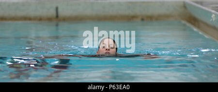 Sgt. Roxanne Rose Ingram, an Automated Logistical Specialist with the 133rd Quartermaster Company of the New York Army National Guard, resurfaces for air during the 100m swim event of the Best Warrior Competition at the pool inside Arvin Gym on West Point on April 22, 2016.     The Best Warrior competitors represent each of New York's brigades after winning competitions at the company, battalion, and brigade levels. At the state level they are tested on their physical fitness, military knowledge, endurance, marksmanship, and land navigation skills. The two winners of the competition, one junio Stock Photo