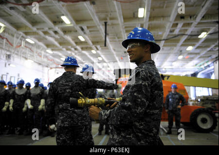 NEWPORT NEWS, Va. (Apr 19, 2016) -- Sailors assigned to Pre-Commissioning Unit Gerald R. Ford (CVN 78) perform firefighting drills in the ship’s hangar bay. Ford is the first of a new class of aircraft carriers currently under construction by Huntington Ingalls Industries Newport News Shipbuilding. (U.S. Navy photo by Mass Communication Specialist Seaman Apprentice Connor Loessin/Released) Stock Photo