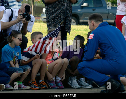 On April 20, 2016 at an elementary school on Maxwell Air Force Base in Alabama, first grade students engage with a visiting U.S. Air Force Lieutenant Colonel who is also a NASA astronaut. The astronaut discusses space exploration, career paths, and the challenges of living and working in space. The event supports educational outreach and inspires students about science, technology, engineering, and space exploration careers. Stock Photo