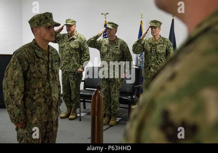 160429-N-RB546-043 NORFOLK, Va. (Apr. 29, 2016) – Naval Officers render honors during the national anthem at Expeditionary Combat Camera’s (EXPCOMBATCAM) change of charge ceremony. EXPCOMBATCAM forces perform unique and highly specialized missions with visual information documentation capabilities supporting all phases of an operation or campaign. (U.S. Navy Combat Camera photo by Mass Communication Specialist 2nd Class Anthony R. Martinez/Released) Stock Photo