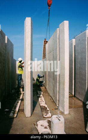 Finishing work on concrete flow channels at the wastewater treatment works for Wigan, England, UK Stock Photo