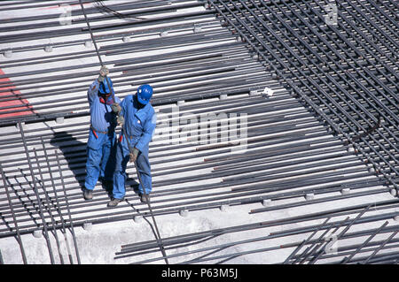 Laying reinforcement out for a major concrete pour in the basement of a tower block of luxury apartments at Dubai marina. Dubai, UAE. Stock Photo