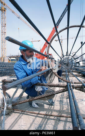 Tying reinforcement for a cylindrical pile cage, Dubai Mall Development, UAE. Stock Photo