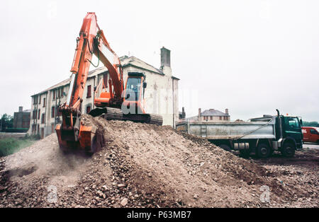 Loading demolition waste on the old housing areas being replaced, Craigmillar regeneration Edinburgh, UK Stock Photo