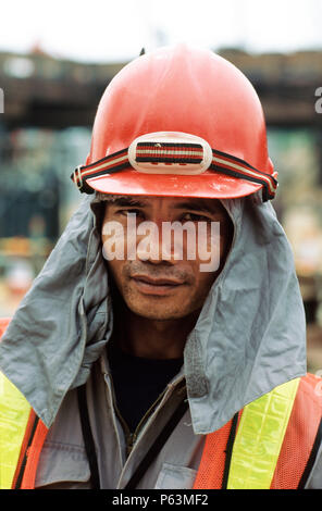 Worker on site in Singapore with sun protection cloth under helmet Stock  Photo - Alamy