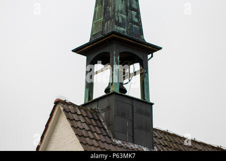 Catholic church bell tower against a overcast sky. Stock Photo