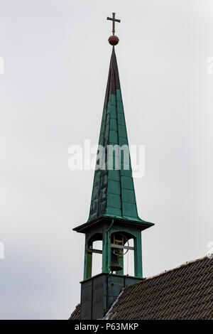 Catholic church bell tower against a overcast sky. Stock Photo